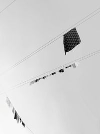 Low angle view of cables against clear sky