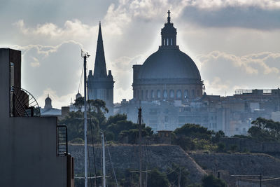 Buildings in city against sky