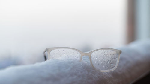 Close-up of eyeglasses on snow