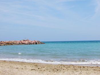 Scenic view of beach against blue sky