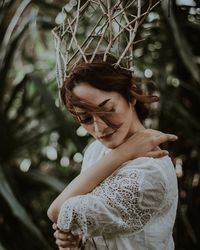 Woman looking at camera in forest