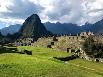 Scenic view of mountains against cloudy sky