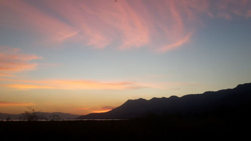Scenic view of silhouette mountains against sky during sunset