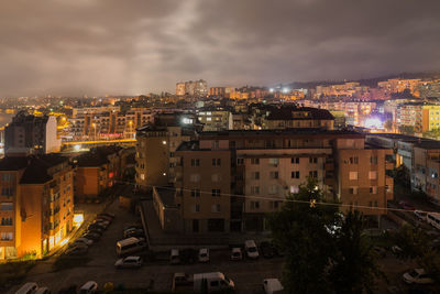 High angle view of illuminated buildings in city at night