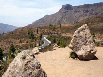 Scenic view of rocks on mountain against sky