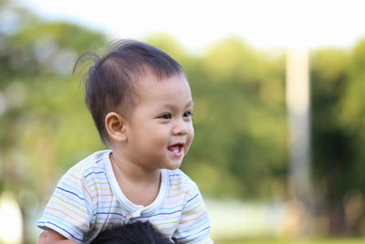 Portrait of cute boy looking away outdoors