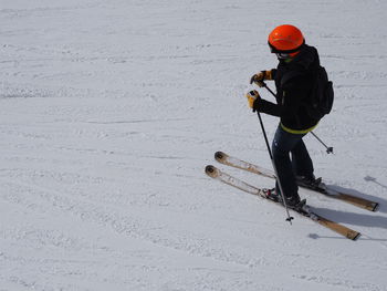 High angle view of skier skiing on snow covered field