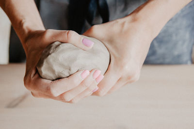 Midsection of woman at pottery workshop