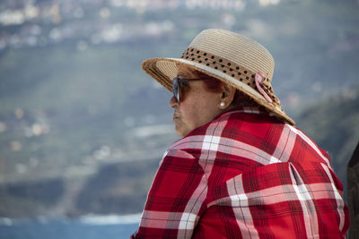 Portrait of man wearing hat looking at sea