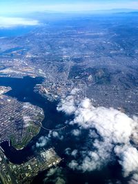 High angle view of sea and cityscape against sky