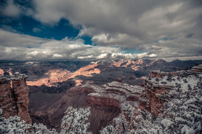 Aerial view of winter canyon landscape against cloudy sky