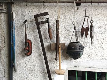 Close-up of objects hanging on metal