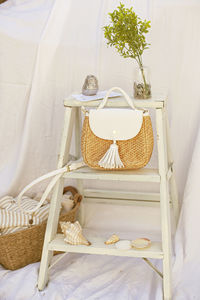 View of white cat in basket on table at home