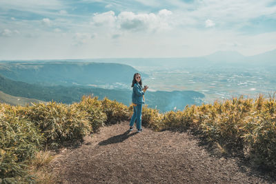 Man standing on mountain against sky