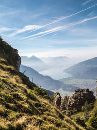 Scenic view of mountain range against cloudy sky