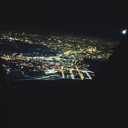 Close-up of illuminated cityscape against sky at night