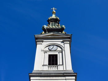 Low angle view of clock tower against clear sky