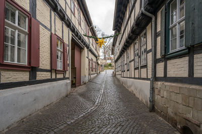 Empty alley amidst buildings in city