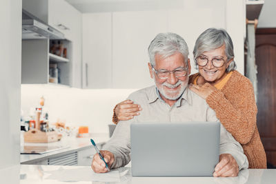 Portrait of young man using laptop at home
