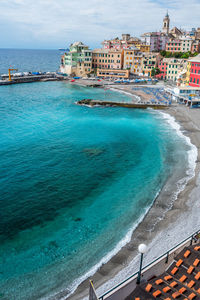 High angle view of sea and buildings against sky