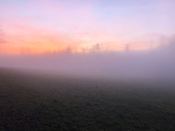 Scenic view of field against sky during sunset