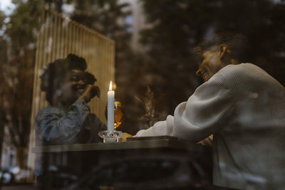 Low angle view of happy multiracial couple having fun during date at restaurant