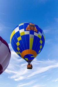 Low angle view of hot air balloon against blue sky