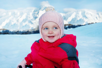 Portrait of smiling boy standing on snow
