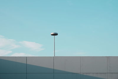 Low angle view of street light against blue sky