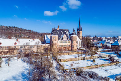 Buildings against blue sky during winter