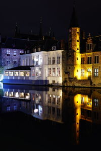 Reflection of buildings in city at night