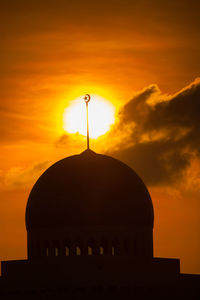 Silhouette temple against sky during sunset