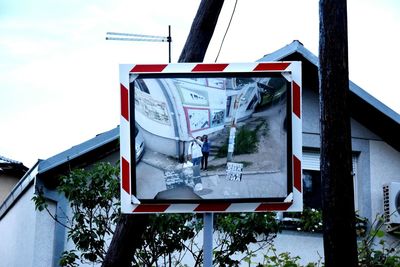 Information sign against sky