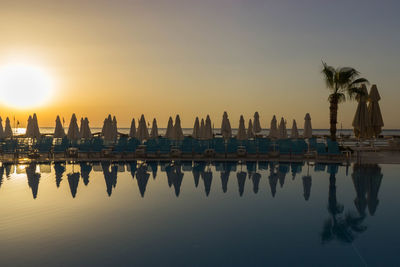 Panoramic view of swimming pool against sky during sunset