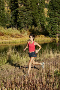 Woman running on lakeshore