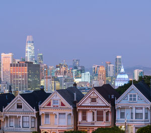 Buildings in city against clear sky