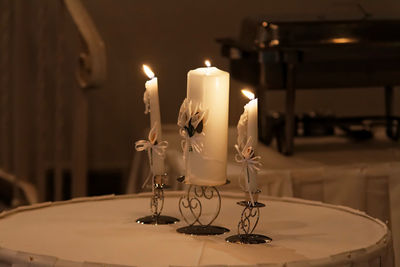 Close-up of lit candles on table
