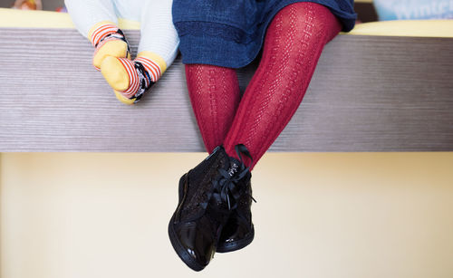 Low section of woman sitting on floor