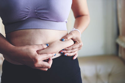 Midsection of woman holding hands