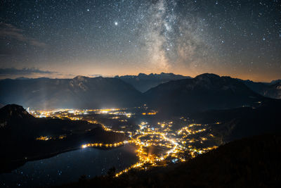 Aerial view of illuminated mountains against sky at night