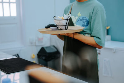 Midsection of woman using laptop on table