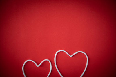 Close-up of heart shape on red wall