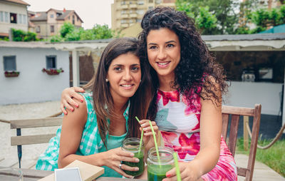 Female friends having drinks at table