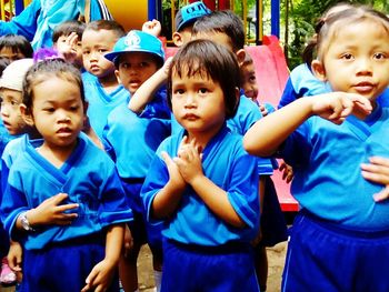 Siblings playing with arms raised