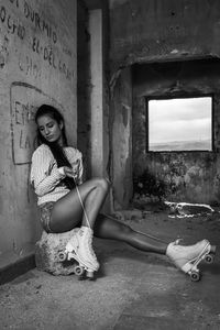 Portrait of woman sitting on wall