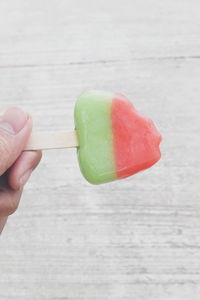 Close-up of hand holding popsicle