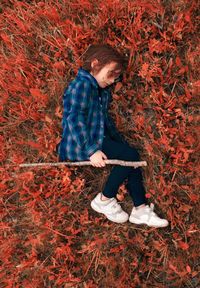 Full length of kid in red grass on land