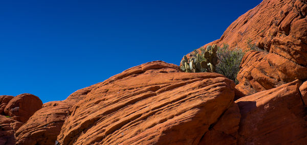 Low angle view of rock formations against clear sky