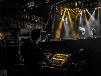 Rear view of man working at music concert