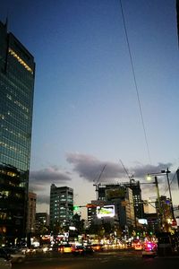 Illuminated cityscape against sky